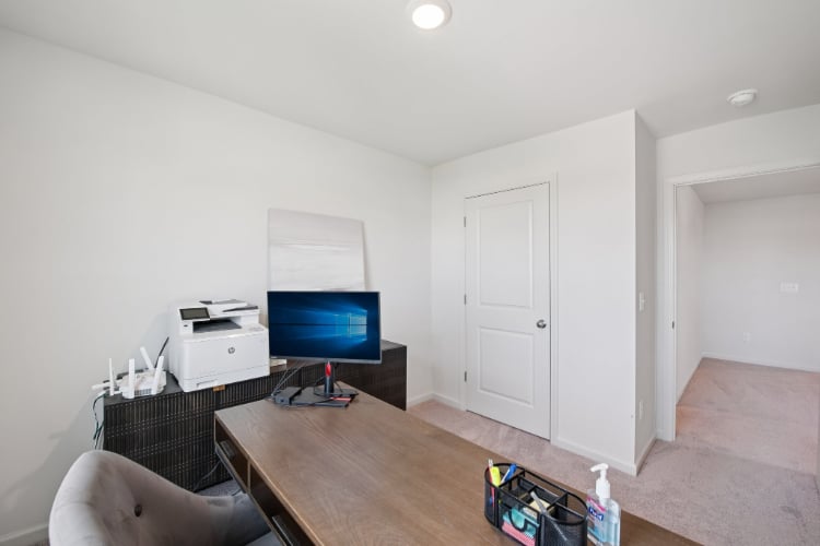 A room with a table and a tv and a chair.