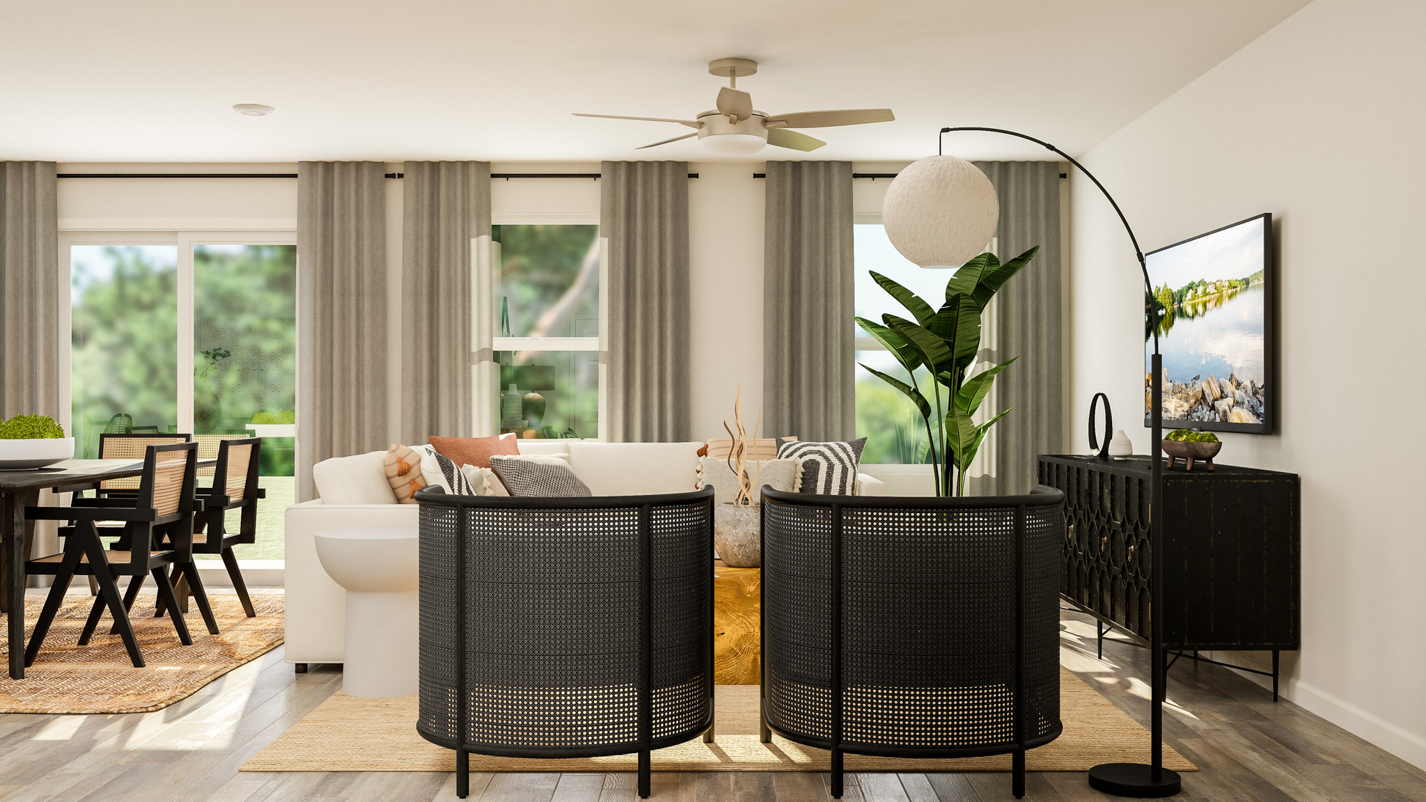 A living room with a white couch and a black table.