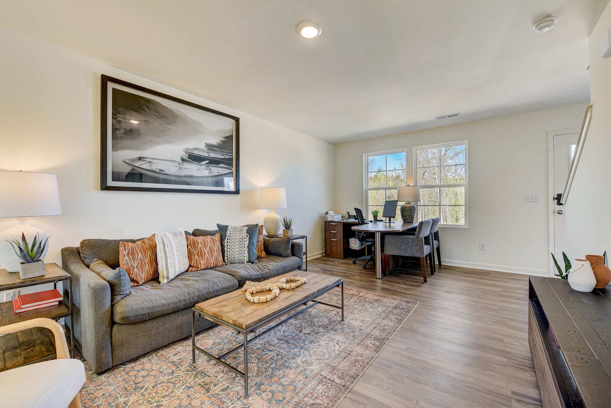 A living room with a large rug.