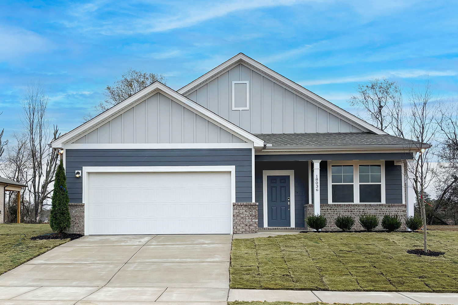 A house with a garage with American Gothic House in the background.