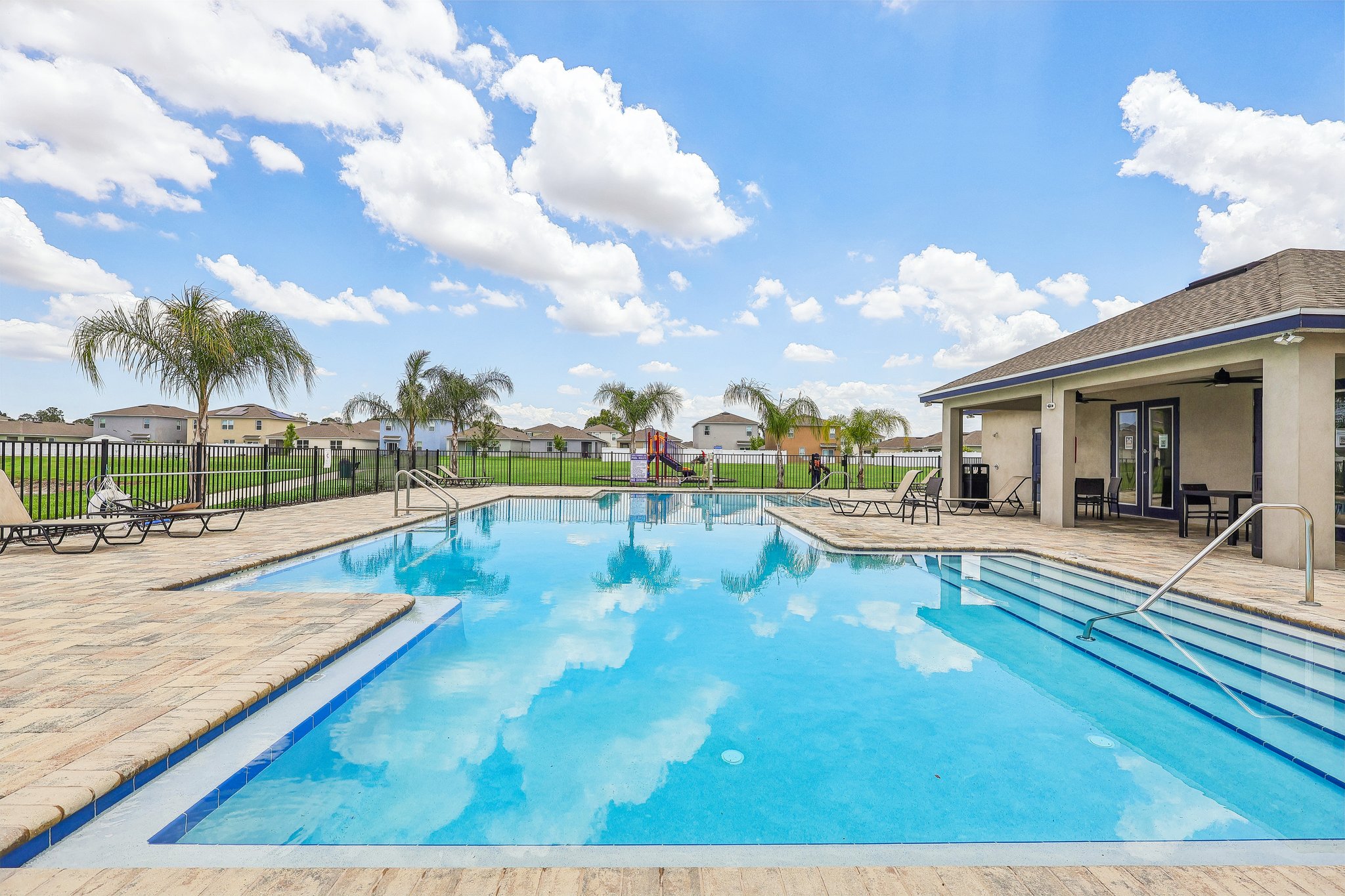 A swimming pool with a building in the background.