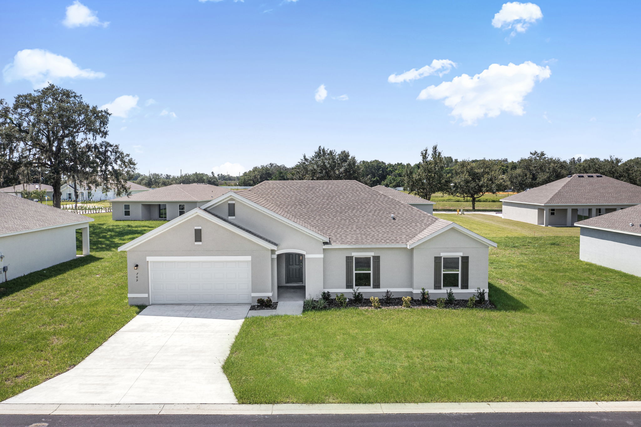 A house with a lawn and trees.
