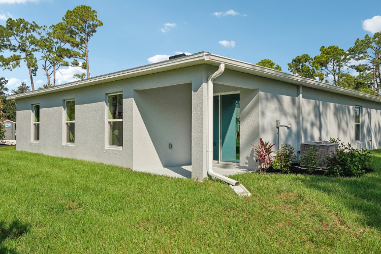 A white house with a garage.