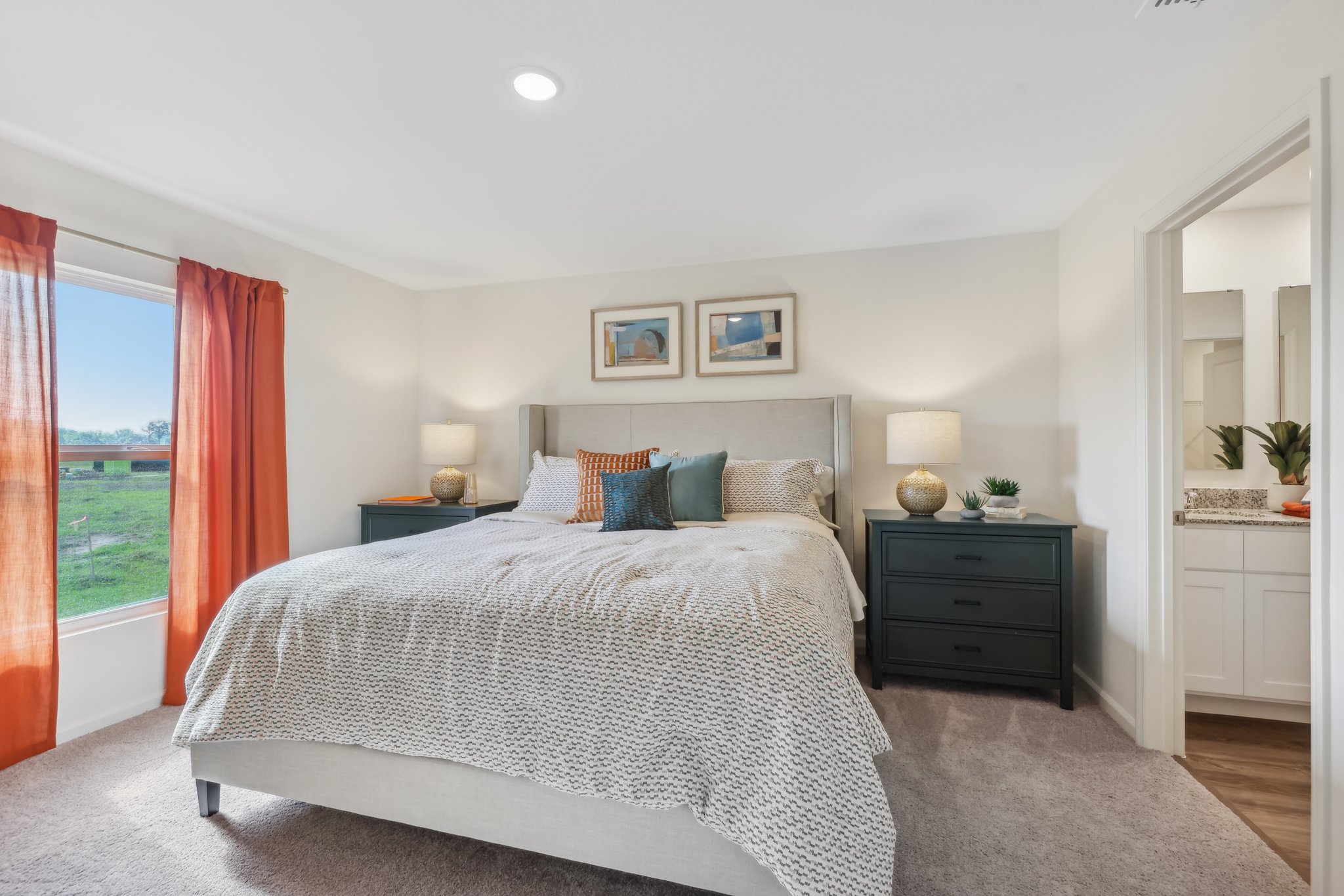 A bedroom with a large window.