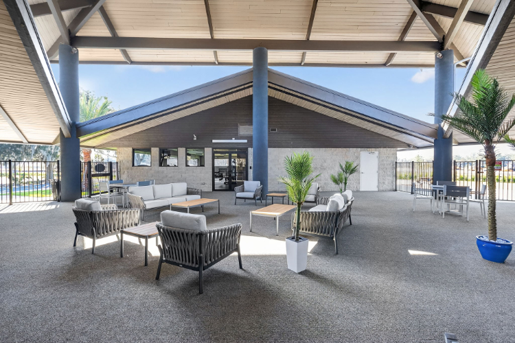 A patio with tables and chairs.