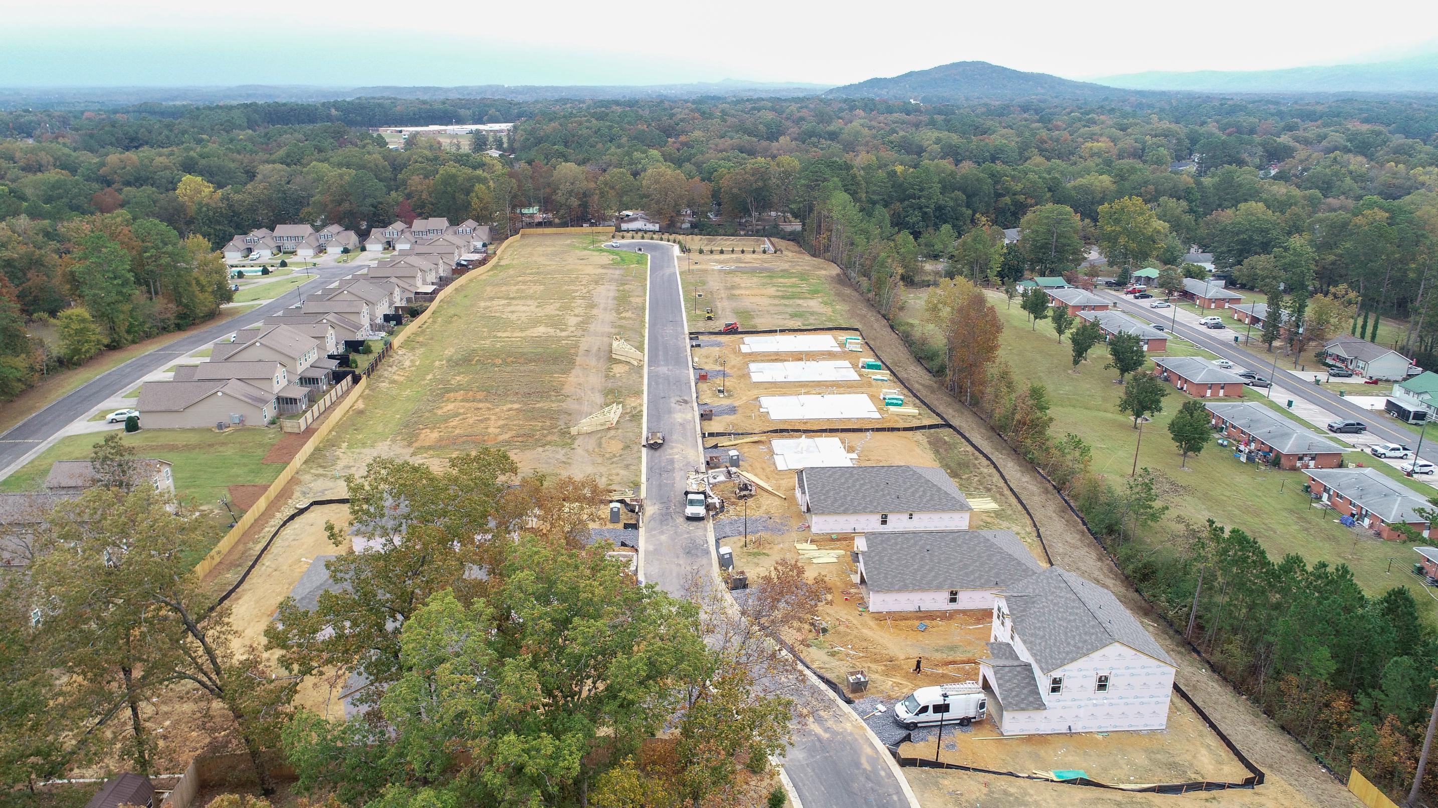 A road with a building and trees.