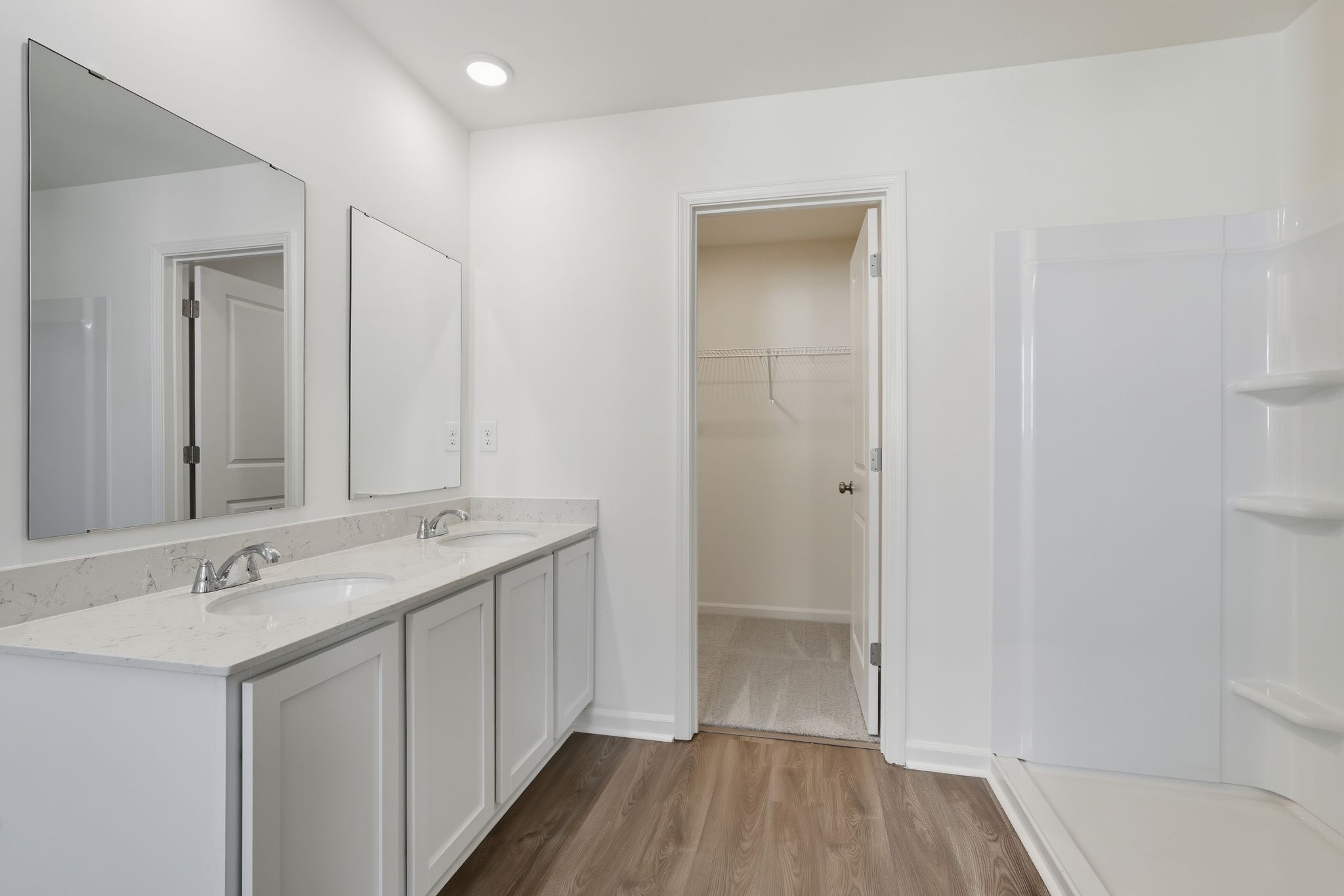 A bathroom with white cabinets.