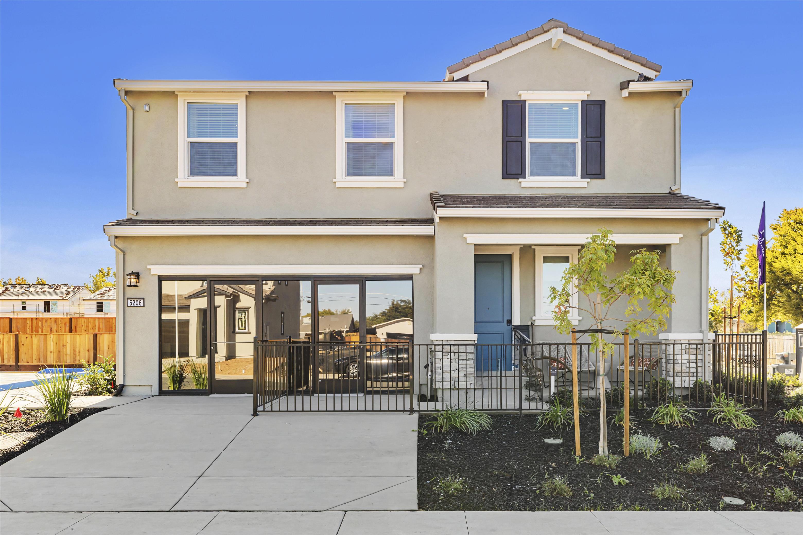 A house with a fence and trees.